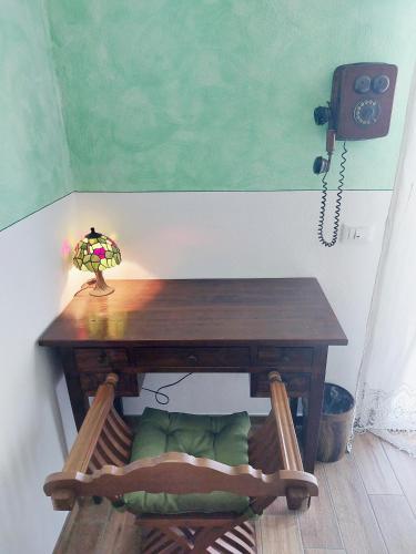 a table with a lamp and a phone on a wall at Tuscan Orchard in Montespertoli