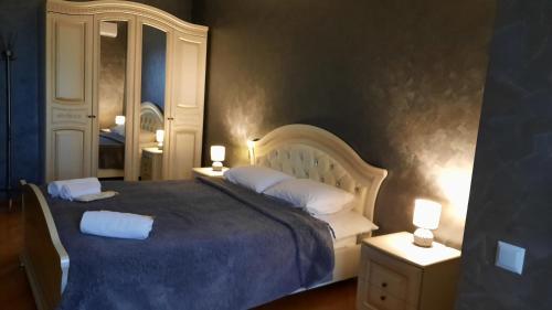 a bedroom with a large bed with two white pillows at Makos Guest House in Kutaisi