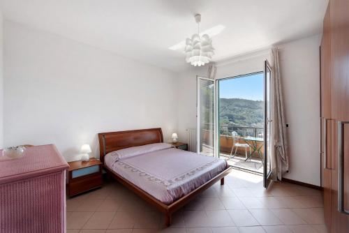 a bedroom with a bed and a large window at Bagetti in Varazze