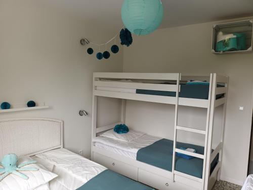a bedroom with two bunk beds and a blue lantern at GRAND T3 FAMILIAL 150m PLAGE LAVANDOU TOUT A PIED !!! PISCINE in Le Lavandou
