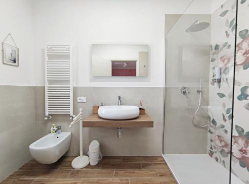 uma casa de banho branca com um lavatório e um chuveiro em Tuscan Orchard em Montespertoli