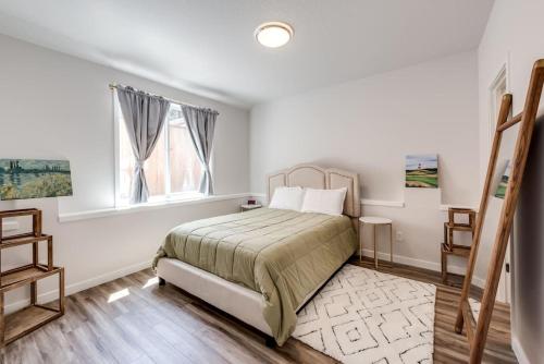 a white bedroom with a bed and a window at Walkable Apt Next to Restaurants, Bars, and Shops! in Portland