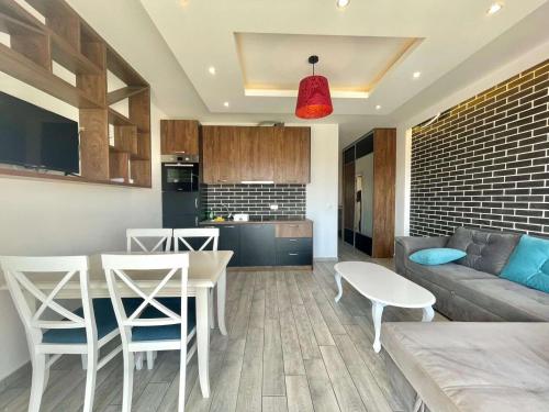 a kitchen and living room with a table and chairs at Bucanero Apartments Budva in Budva