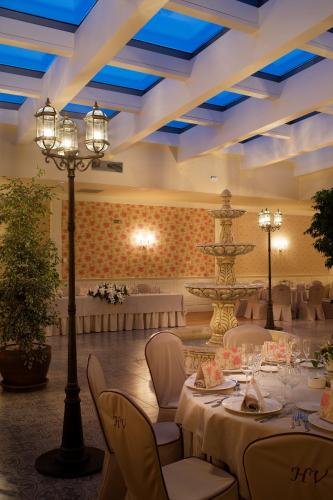 a banquet hall with tables and a fountain in the middle at Hotel Restaurante El Valles 4 ESTRELLAS in Briviesca