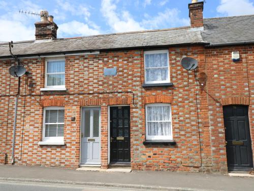 a brick building with two windows and a door at Castle Cottage in Newport