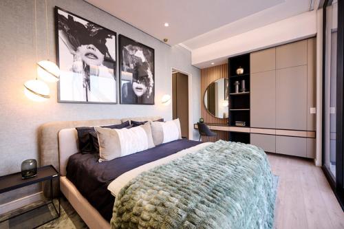 a bedroom with a large bed in a room at Ellipse Waterfall Executive Apartments in Midrand