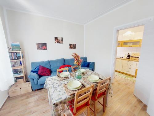 a living room with a table and a blue couch at Tuscan Orchard in Montespertoli