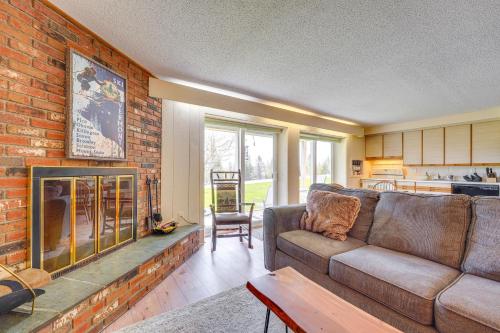 a living room with a couch and a fireplace at Ski-inandSki-Out Peru Condo with Fire Pit and Grill! in Peru