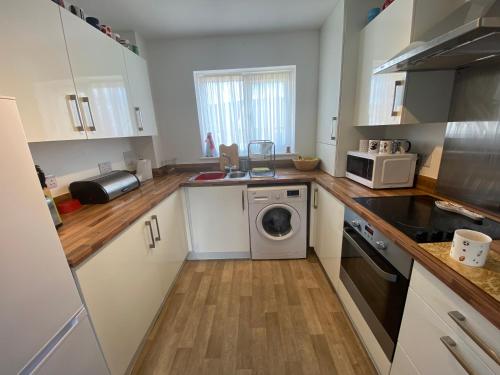 a kitchen with a washing machine and a washer at Bodmin Rest 4 U in Bodmin