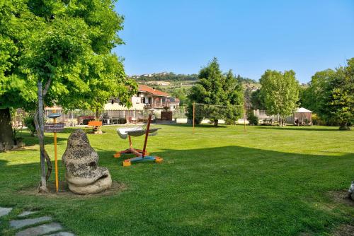 a park with a playground with a swing at Appartamento Iris in Cisterna dʼAsti