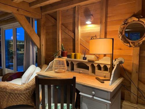 a room with a desk in a log cabin at The Hen House - Cosy Retreat, Scenic Countryside 