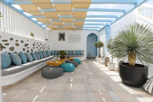 a lobby with blue chairs and a table at Ibiscus Boutique in Mýkonos City