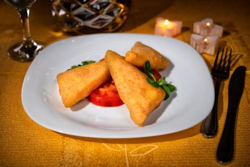 a white plate with some food on a table at Casa Maria Arges in Piteşti