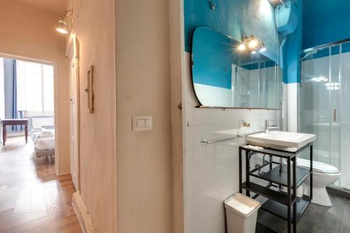 a bathroom with a toilet and a sink and a mirror at Ginori 3P in Florence