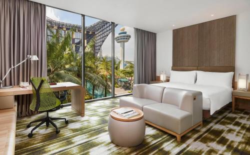 a hotel room with a bed and a desk at Crowne Plaza Changi Airport by IHG in Singapore