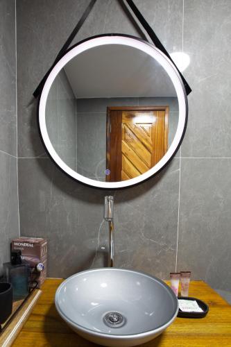 a bathroom sink with a large mirror above it at Casa Ferreira Cumbuco in Caucaia