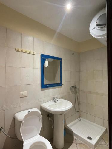a bathroom with a toilet and a sink at Almar Apartments in Durrës