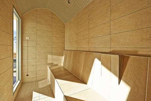 a room with a bench and a window at Hotel Planai by Alpeffect Hotels in Schladming