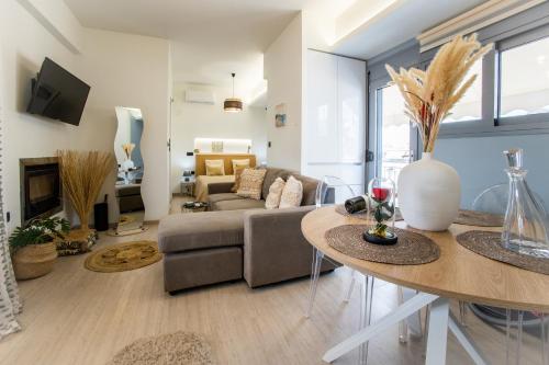 a living room with a couch and a table at Athens luxurious loft in Athens