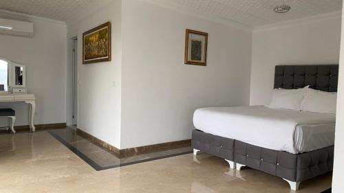 a bedroom with a bed and a sink in a room at Palm Beach Şile Villa Hotels in Istanbul