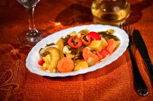 a white plate of food on a table at Casa Maria Arges in Piteşti