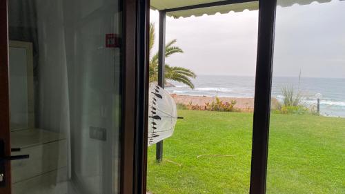 a view of the ocean from a house window at Palm Beach Şile Villa Hotels in Istanbul