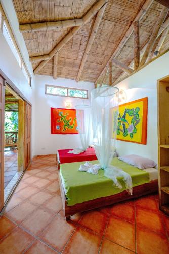 a bedroom with two beds in a room at Private Villa on 2-Acres of Jungle Garden & Pool in Manzanillo