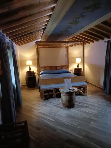 a bedroom with a bed and a table and two lamps at Villa Agnolaccio Residenza d'Epoca in Pistoia