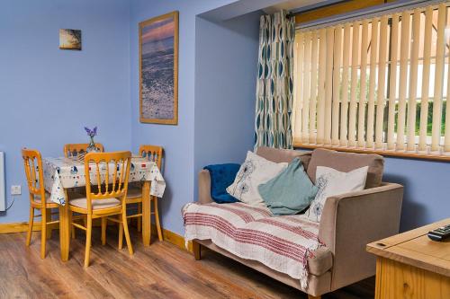 a living room with a couch and a table at Finest Retreats - New Inn Lodge in East Dereham