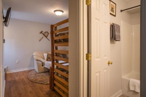 a room with a stairs leading to a living room at Sasquatch Lodge A sleeps 12 in Gatlinburg