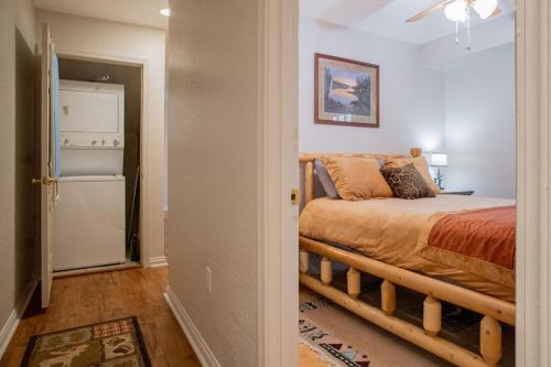 a bedroom with a bed and a refrigerator at Sasquatch Lodge A sleeps 12 in Gatlinburg