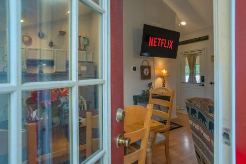 a kitchen and dining room with a sign on the door at Sasquatch Lodge A sleeps 12 in Gatlinburg