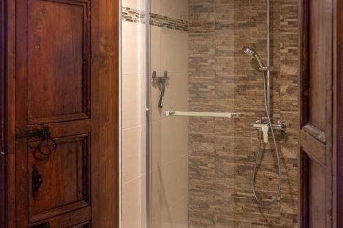 a bathroom with a shower with a glass door at Babel Suites in Valletta