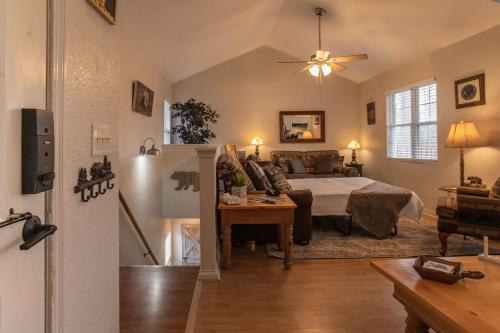 a bedroom with a bed and a living room at Sasquatch Lodge A sleeps 12 in Gatlinburg