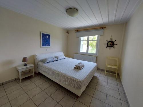 a bedroom with a bed with a stuffed animal on it at Palaiokrassa sunny appartment in Andros