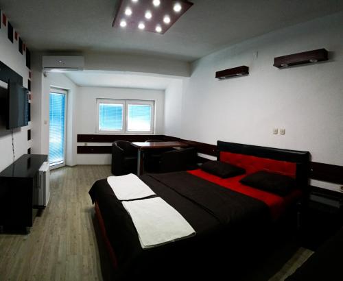 a bedroom with a bed and a desk in it at Kice Apartments in Ohrid