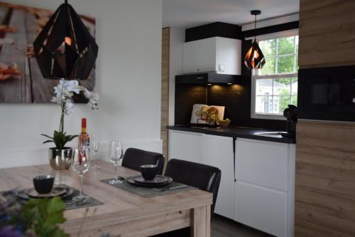 a kitchen with a wooden table and a dining room at Holiday Inn 30 # Airco # hygiëne # Efteling # Beekse Bergen # Festival Best Kept Secret in Oisterwijk