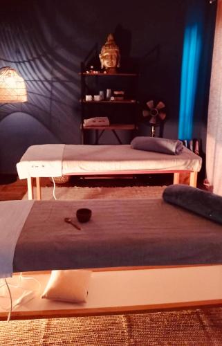 two beds sitting in a room with at Villa Nonna Cicci Boutique Hotel - SPA in Cisterna dʼAsti