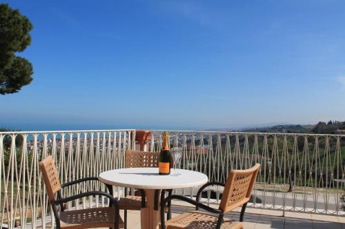 a bottle of wine sitting on a table on a balcony at Il Parco Sul Mare Resort & SPA in Tortoreto Lido