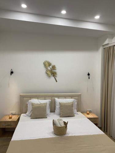 a bedroom with a large bed with white sheets at Xhan Apartments in Ulcinj