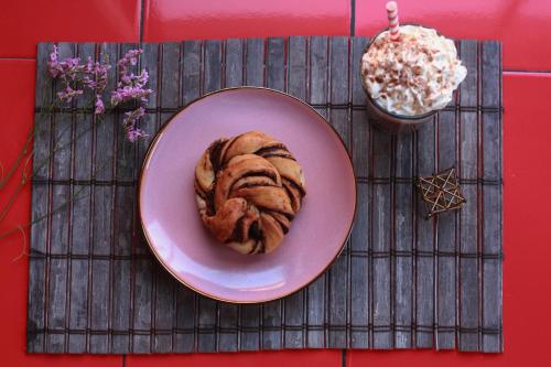 a plate of bread on a placemat with a dessert at Meraki Hostel - Cerro Alegre - Valparaíso in Valparaíso