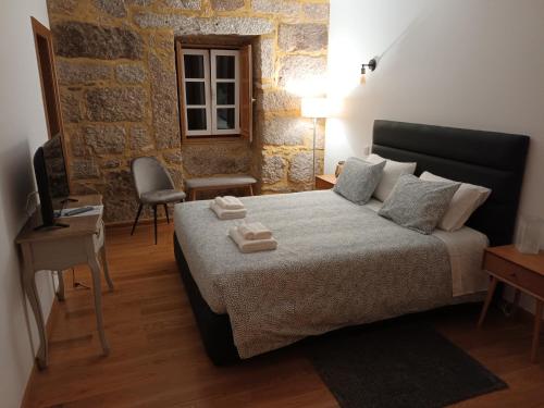 Ένα ή περισσότερα κρεβάτια σε δωμάτιο στο Casa de Ferrapilhe