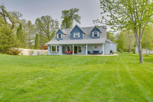 a blue house with a large grass yard at Stunning Waterville Home on Tetonka Lake! in Waterville