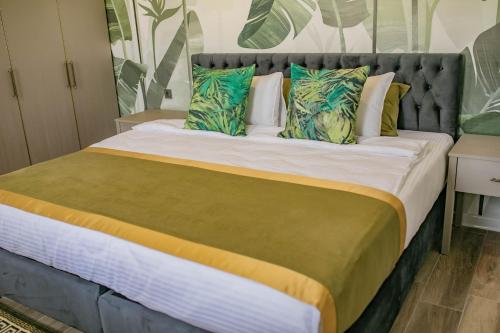 a bedroom with a large bed with colorful pillows at The Green Oasis Otel Spa in Kadıköy