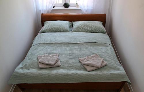a bed with two pillows on it in a bedroom at Dom Mazury in Piecki