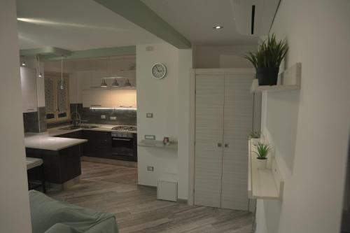 a kitchen with white cabinets and a kitchen with a counter at L'ANGOLO VERDE in Cascina