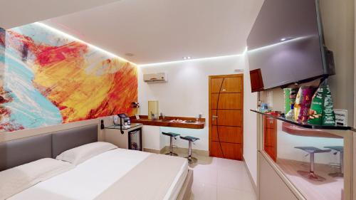 a small room with a bed and a sink at Motel DUBAI BH in Belo Horizonte