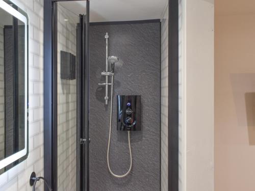 a shower in a bathroom stall with a shower at Chyvelyn in Perranporth