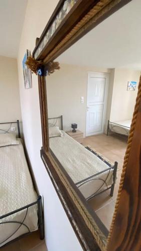 two bunk beds in a room with a mirror at Poppy's House in Emborios Kalymnos