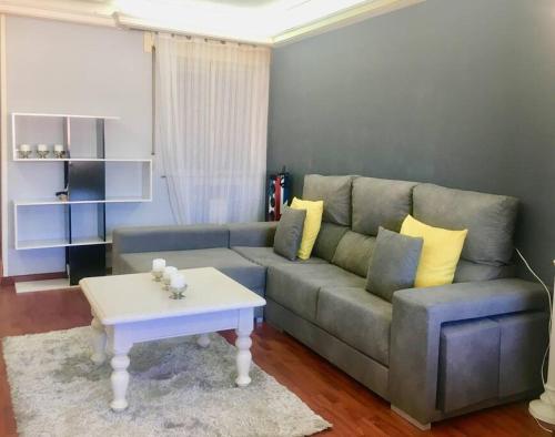 a living room with a couch and a coffee table at Apartamento Lugo Centro in Lugo